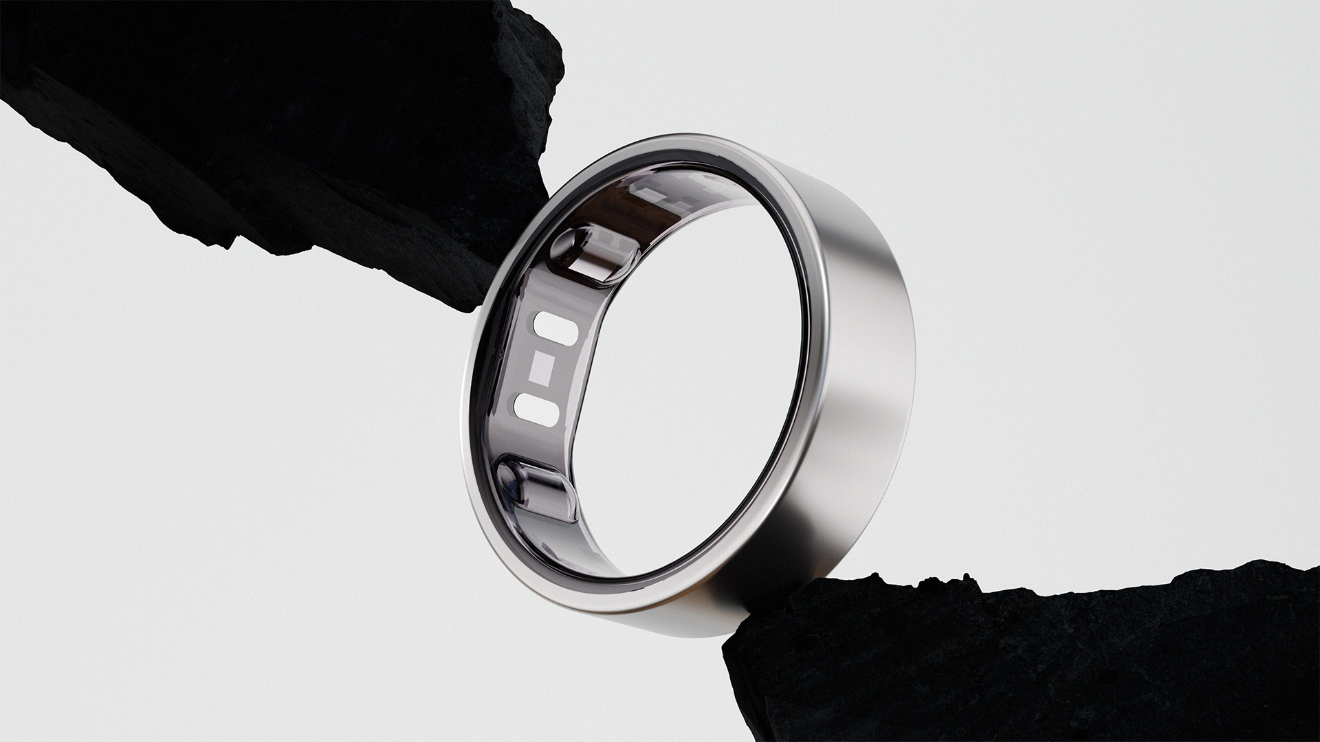 Silver Reebok Smart Ring 3D render with rock background